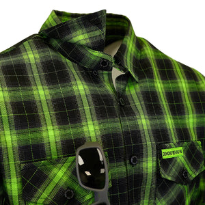 A close-up of a green and black plaid button-down shirt on a white background, featuring a chest pocket with a visible 'CROSS BEND SHIRT' label and sunglasses resting in the pocket.