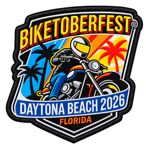 A shield-shaped embroidered patch for BIKETOBERFEST Daytona Beach 2026 Florida, featuring a stylized motorcyclist with palm trees and a sunset background.