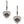 A pair of silver heart-shaped dangle earrings with clear pavé stones and a central black Harley-Davidson bar logo, shown on a plain white background.