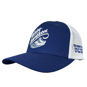 A navy blue and white trucker hat featuring a white Harley-Davidson logo on the front and text on the side mesh panel, shown against a plain white background.