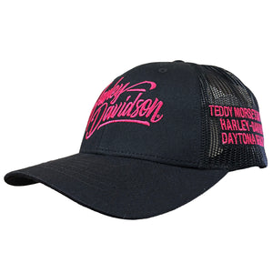 A black trucker-style baseball cap with pink embroidered Harley-Davidson script on the front and pink text on the side mesh panel, shown on a plain white background.