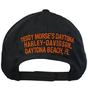 Black baseball cap with orange embroidered text reading 'TEDDY MORSE'S DAYTONA HARLEY-DAVIDSON DAYTONA BEACH, FL' on the front panel, shown against a plain white background.