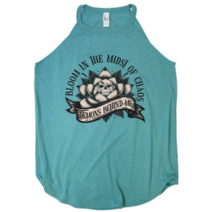 A teal heathered sleeveless tank top featuring a black graphic print of a skull in a lotus flower with the text 'BLOOM IN THE MIDST OF CHAOS' and 'DEMONS BEHIND ME'.