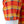 Close-up of a plaid shirt sleeve on a white mannequin torso, featuring orange, red, yellow, and brown stripes with a small circular skull patch near the cuff.