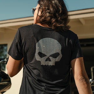 Person wearing a black t-shirt with a skull design outdoors