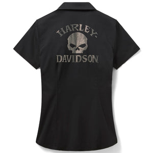 A black short-sleeve button-up shirt shown from the back, featuring a distressed gray Harley-Davidson logo with a skull graphic on the upper back.