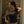 Person wearing a Harley Davidson t-shirt in front of a decorative wooden door.