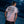Person wearing a Harley-Davidson t-shirt with tattoos visible on arms, standing against a dark background.