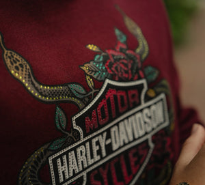 Harley-Davidson logo with a snake and rose design on a red background