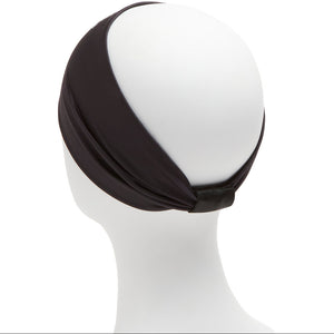 Black headband on a mannequin head against a white background