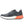 Gray athletic shoe with orange sole on a white background