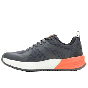Gray athletic shoe with orange sole on a white background