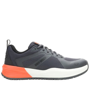 Gray athletic shoe with orange sole on a white background