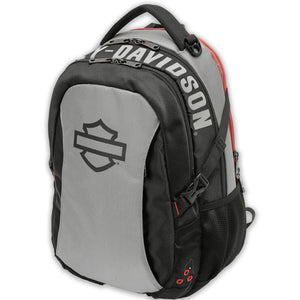 A gray and black Harley-Davidson backpack with a large black shield logo on the front pocket and white Harley-Davidson lettering on the side, shown on a plain white background.