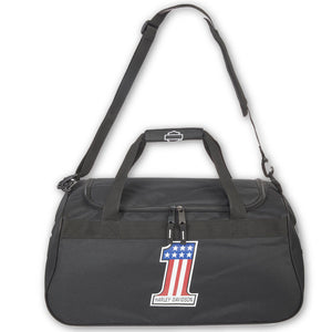 A black nylon duffel bag with a top handle, shoulder strap, and a front zippered pocket. The front pocket features a graphic of a number 1 styled with the American flag and a 'HARD WORK精神' patch below it.
