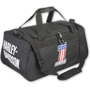 A black Harley-Davidson duffel bag with white logo text on the side and a red, white, and blue American flag patch on the front, shown on a white background.