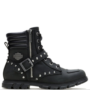 A black leather motorcycle-style ankle boot with silver hardware, including studs, buckles, and a Harley-Davidson logo patch, shown on a plain white background.
