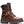 A brown leather motorcycle-style boot with a dark brown collar, lace-up front, decorative buckle strap, and a brass-tone Harley-Davidson logo patch on the side, shown against a plain white background.