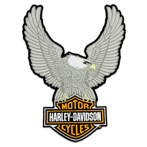 An embroidered patch featuring a large gray eagle with outstretched wings above a Harley-Davidson Motor Cycles logo, on a plain white background.