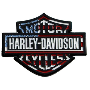 A Harley-Davidson bar and shield style patch or emblem with a distressed American flag pattern in red, white, and blue, outlined in black, on a plain white background.