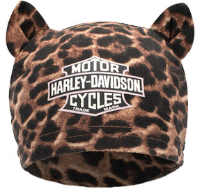 A leopard-print beanie hat with two small cat ears on top and a large Harley-Davidson logo patch on the front, shown against a plain white background.