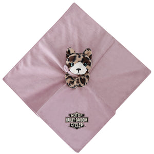 A dusty pink square comforter or blanket with a small plush leopard toy attached at the center and a Harley-Davidson Cycles logo patch near the bottom corner, shown on a plain white background.