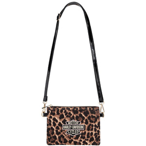 A Harley-Davidson crossbody bag featuring a brown and black leopard print pattern, a black shoulder strap, and a gold-tone Harley-Davidson logo patch on the front.