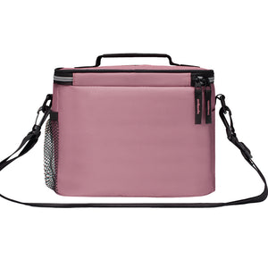 A dusty pink soft-sided lunch bag with black trim, a top handle, a detachable shoulder strap, and a side mesh pocket, shown on a plain white background.