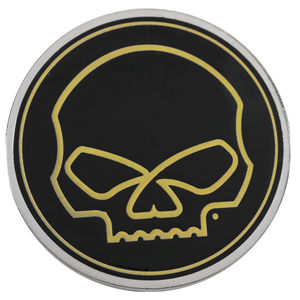 A circular black car emblem featuring a stylized yellow skull graphic, surrounded by a silver metallic border, shown on a plain white background.