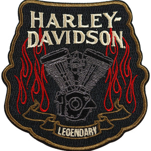 An embroidered Harley-Davidson patch featuring a black background, a gray engine illustration, red flames, and cream lettering that reads 'HARLEY-DAVIDSON' and 'LEGENDARY'.
