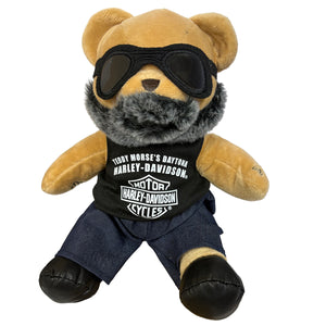 Plush bear wearing sunglasses, a Harley-Davidson t-shirt, and jeans on a white background