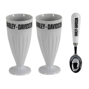 Two white Harley-Davidson milkshake glasses with black lettering, shown alongside a matching white and black ice scoop on a plain white background.