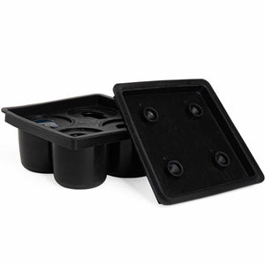 Black plastic seed starter tray with a square lid showing four raised circular spots, next to a tray showing three cylindrical wells, photographed on a white background.