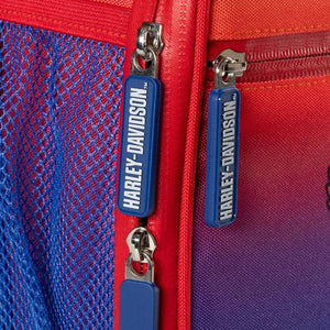 Close-up of a red and blue bag with Harley-Davidson zippers.