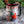 Mug with a printed design of a red motorcycle and Christmas tree, placed on a marble surface with greenery in the background.