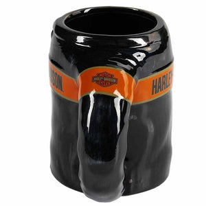 A glossy black ceramic mug shaped like an elephant, featuring an orange band around the middle with Harley-Davidson branding.