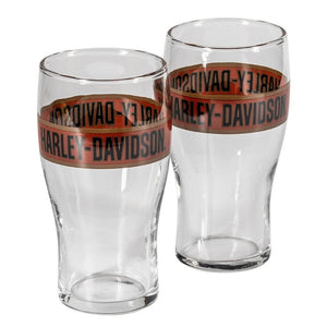 Two clear pint glasses with a brown and black Harley-Davidson logo band around the middle, shown on a plain white background.