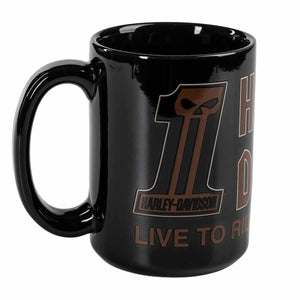 A glossy black ceramic mug featuring a brown and white graphic design with the number 1, a skull motif, and the text 'HARLEY-DAVIDSON' and 'LIVE TO RIDE'.