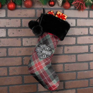 Plaid Christmas stocking with Harley-Davidson logo on a brick wall background
