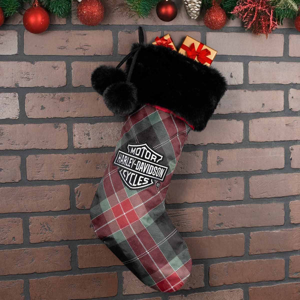 Plaid Christmas stocking with Harley-Davidson logo on a brick wall background