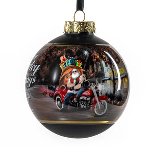 Decorative Christmas ball ornament with a motorcycle-riding Santa Claus design.
