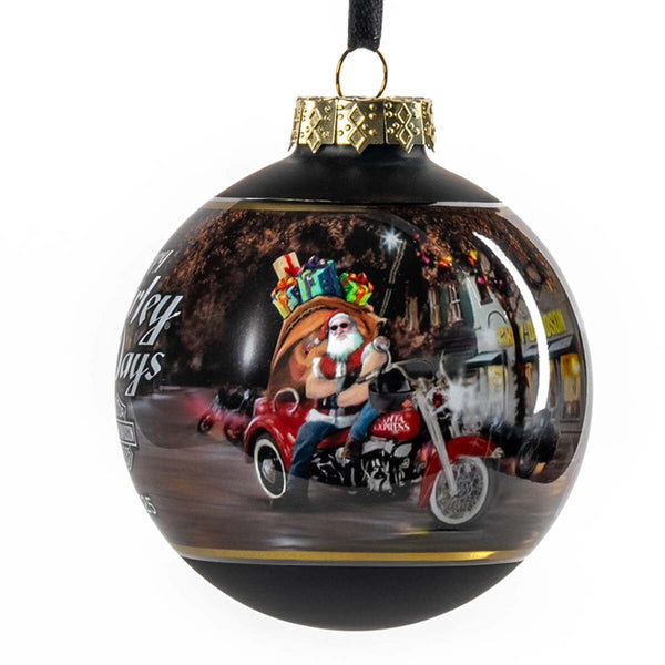 Decorative Christmas ball ornament with a motorcycle-riding Santa Claus design.