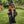 Gnome wearing a Harley-Davidson cap and leather jacket holding a helmet on grass