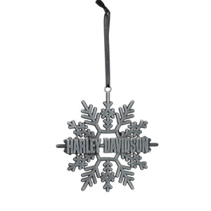 A dark gray metal snowflake Christmas ornament featuring the Harley-Davidson logo in the center, suspended by a black ribbon against a plain white background.