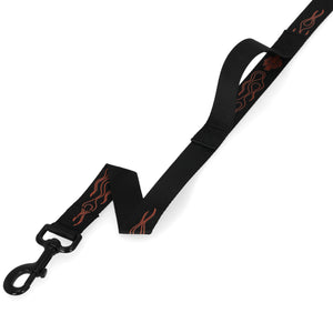 A black dog leash with a black metal clasp and orange flame patterns, shown on a plain white background.