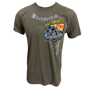 An olive green short-sleeve t-shirt with a graphic print for 'Biketoberfest 2026' in Daytona Beach, Florida. The graphic features a motorcycle and a colorful shield design with gothic text.