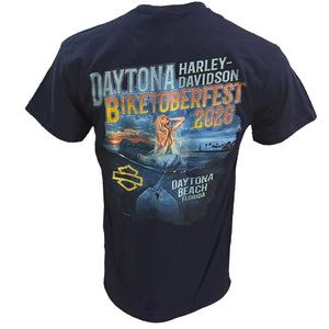 A navy blue short-sleeve t-shirt showing the back graphic print for the 'Daytona Harley-Davidson Biketoberfest 2026'. The graphic features a colorful sunset scene with a woman in a boat, a shark, and a yellow Harley-Davidson logo.