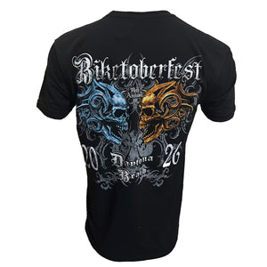 A black short-sleeve t-shirt shown from the back, featuring a large graphic print of two skulls facing each other. The left skull is blue and the right skull is gold, with the text 'Biktoberfest', '34th Annual', 'Santa Ana Beach', and numbers '20' and '26' in white gothic lettering.